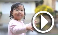 Une petite fille découvre la pluie avec émerveillement